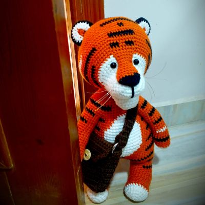 A tiger wearing a bag