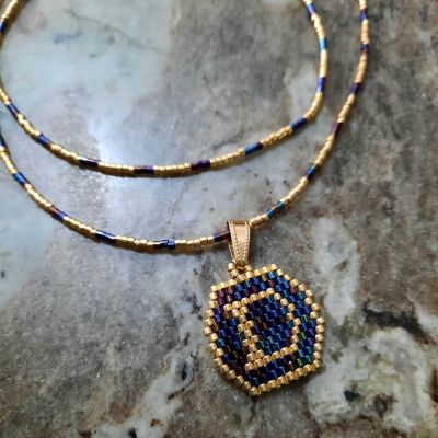 A necklace with a letter design by Miyuki beads