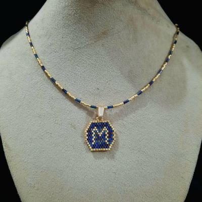 A necklace with a letter design by Miyuki beads