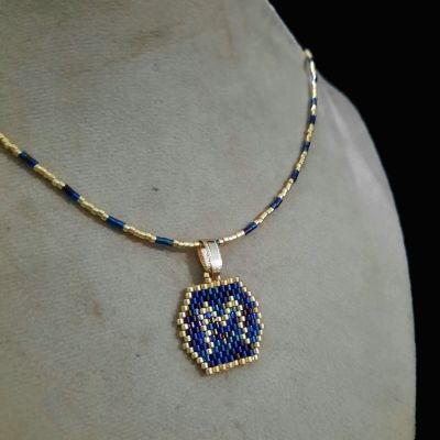 A necklace with a letter design by Miyuki beads