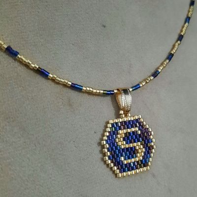 A necklace with a letter design by Miyuki beads