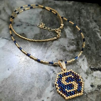 A necklace with a letter design by Miyuki beads