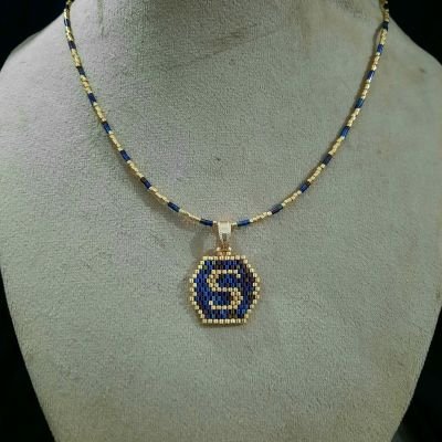 A necklace with a letter design by Miyuki beads