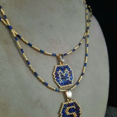 A necklace with a letter design by Miyuki beads