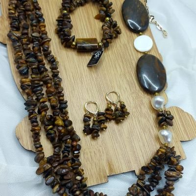 A set consisting of a necklace, earrings, and bracelet made of Tiger's Eye stones .