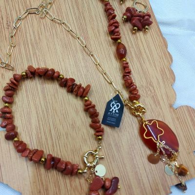 A set including a necklace, earrings, and a bracelet, made from broken agate stones