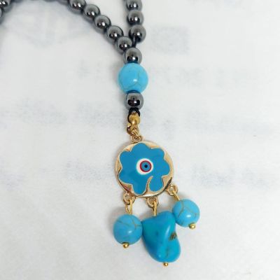 A prayer necklace made from hematite stones, with turquoise spacers.