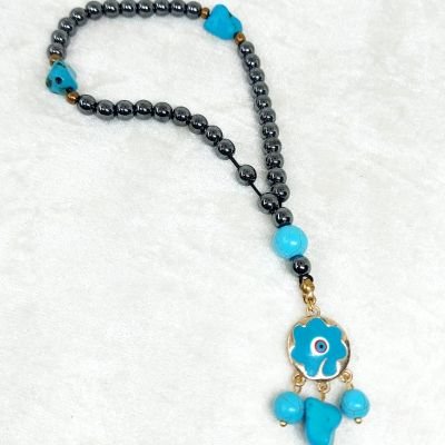 A prayer necklace made from hematite stones, with turquoise spacers.