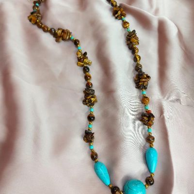 A necklace made of tiger's eye and turquoise stones.