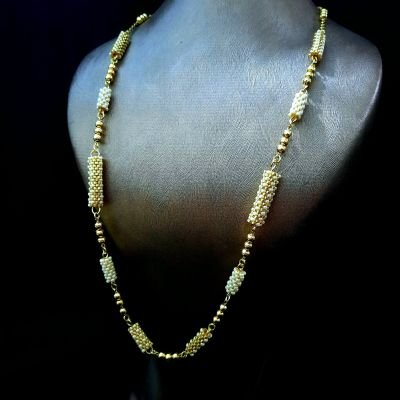 A necklace with a gold-tone motif and pearl-colored Miyuki beads
