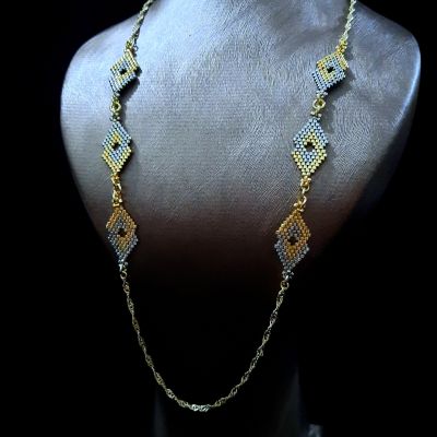 A necklace with geometric designs in gold and silver, made from Miyuki beads.