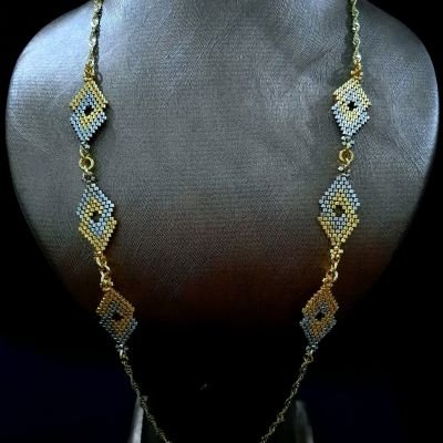 A necklace with geometric designs in gold and silver, made from Miyuki beads.