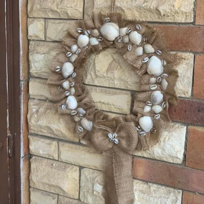 A burlap hoop inlaid with seashells