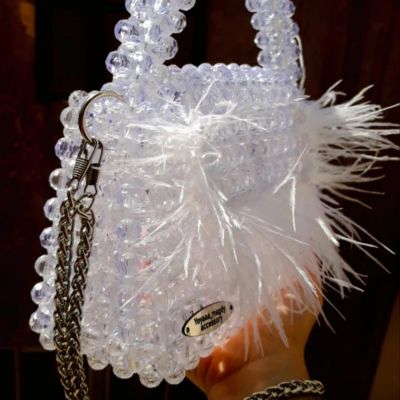 Crystal clear bag with feathers and fixed handle