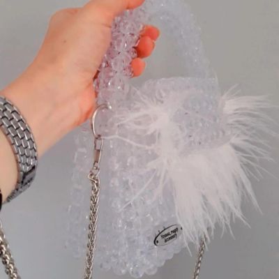 Crystal clear bag with feathers and fixed handle