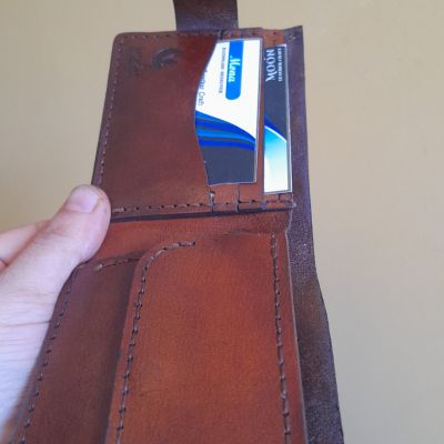 A men's pocket wallet made of natural leather with the name and photo engraved on it 