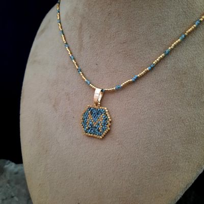 A necklace with a letter design by Miyuki beads