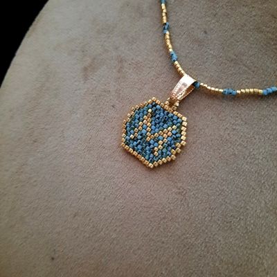 A necklace with a letter design by Miyuki beads