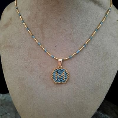 A necklace with a letter design by Miyuki beads