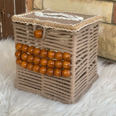 A box of tissues with macrame cordon