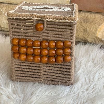 A box of tissues with macrame cordon