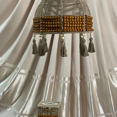 A box of tissues with macrame cordon