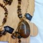 A set consisting of a necklace, bracelet, and earrings made of Tiger's Eye stones.