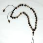 A mobile chain and prayer necklace made from tiger eye stones.