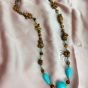 A necklace made of tiger's eye and turquoise stones.