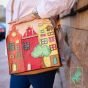A natural leather bag with colorful houses on it