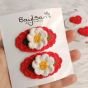 double clips.. covered with a flower.. red